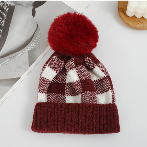 Checkered hat with fur ball