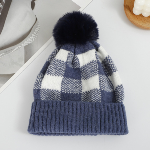 Checkered hat with fur ball