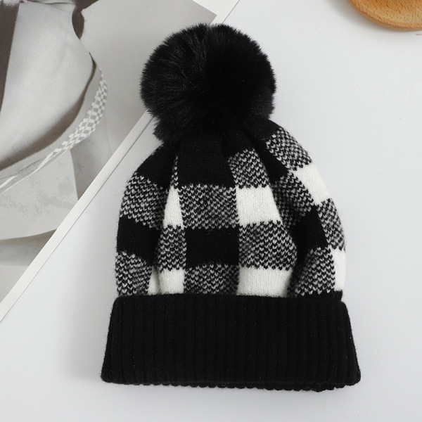 Checkered hat with fur ball