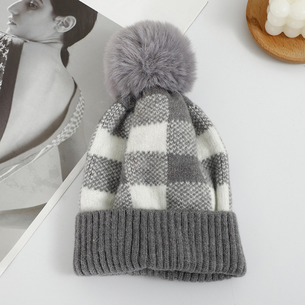 Checkered hat with fur ball