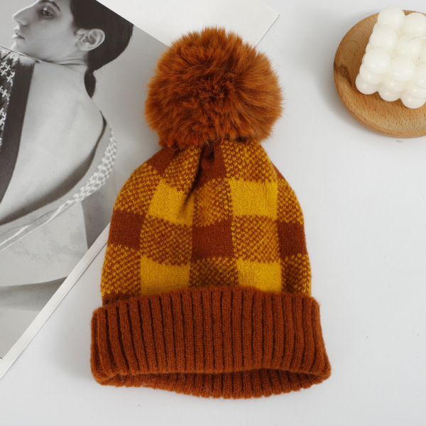 Checkered hat with fur ball