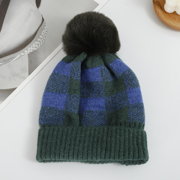 Checkered hat with fur ball